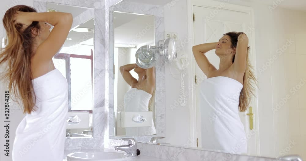 Young girl admiring reflection in mirror Young girl admiring reflection in mirror