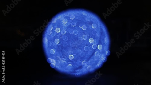 Blinking, glittering and sparkling blue bokeh lights of the New Year or Christmas light ball in night illumination