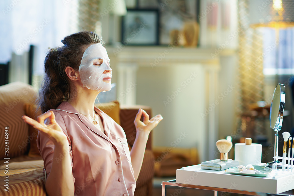 relaxed elegant woman with facial mask meditating - obrazy, fototapety, plakaty 