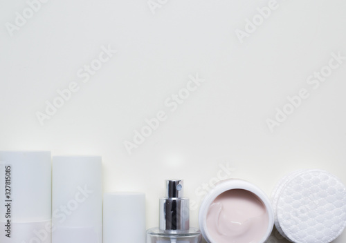 Facial cleansing products and containers with face creams and cotton wool pads