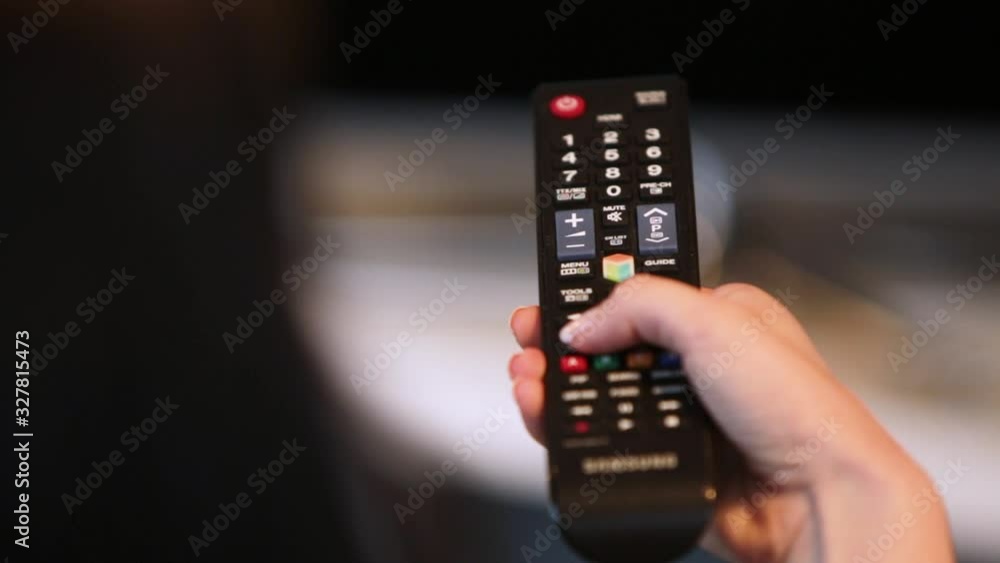 Close Up Shot Of A Woman's Hand Holding A Remote Control. Changing Channels. Zapping Close Up Shot Of A Woman's Hand Holding A Remote Control. Changing Channels. Zapping