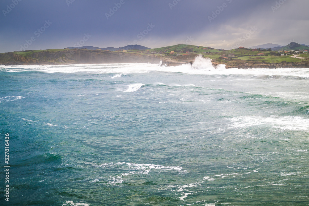 Bahia de Suances in storm day with strong waves and dramatic sky