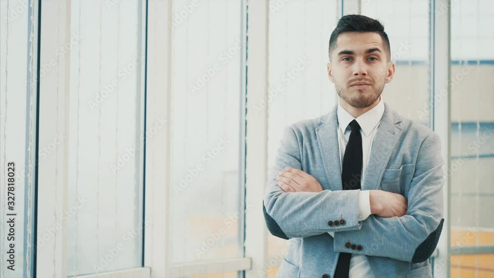 Business man is serious, looking at the camera, isolated on white blurred background. Copy space. 4K. Business man is serious, looking at the camera, isolated on white blurred background. Copy space. 4K.