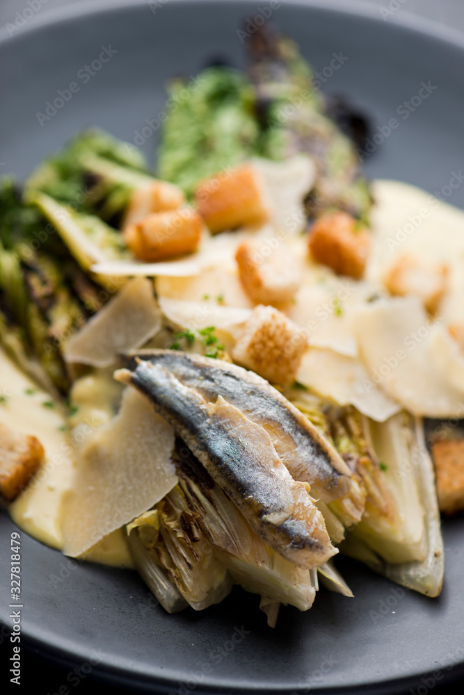 Caesar Salad. Grilled Romaine lettuce leaves topped with classic Caesar