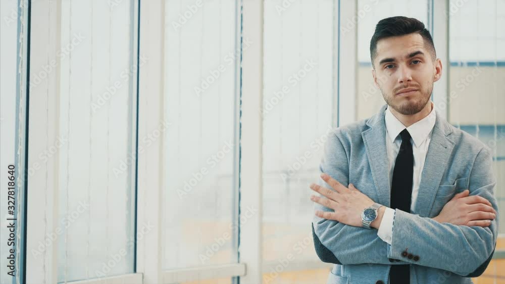 Business man is serious with his hands crossed or folded while posing, isolated on white panoramic background. Copy space. 4K. Business man is serious with his hands crossed or folded while posing, isolated on white panoramic background. Copy space. 4K.