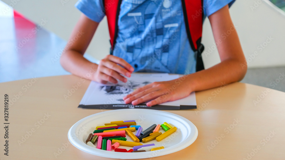 Boy draws with colored wax crayons Boy draws with colored wax crayons