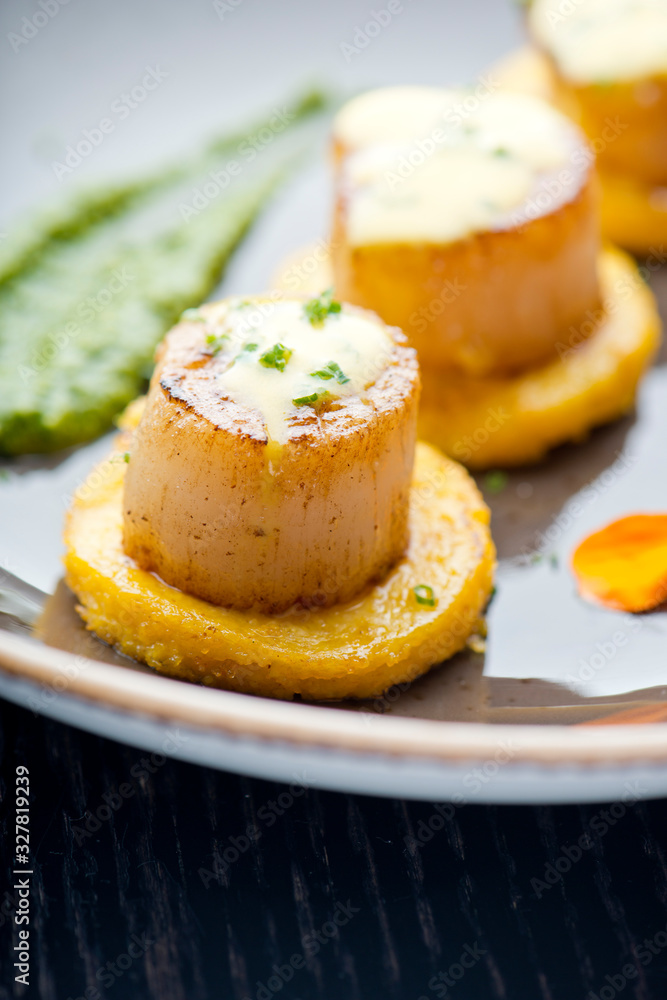 Scallops. Sea Scallops seared in brown butter sauce and garnished with a lemon sauce. Scallops. Sea Scallops seared in brown butter sauce and garnished with a lemon sauce.