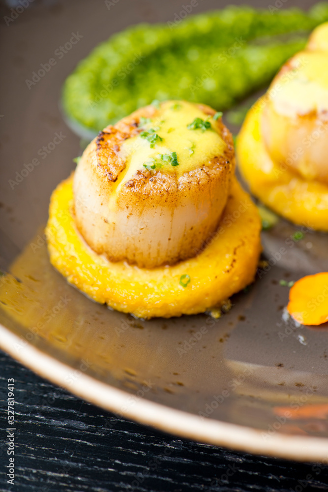 Scallops. Sea Scallops seared in brown butter sauce and garnished with a lemon sauce. Scallops. Sea Scallops seared in brown butter sauce and garnished with a lemon sauce.