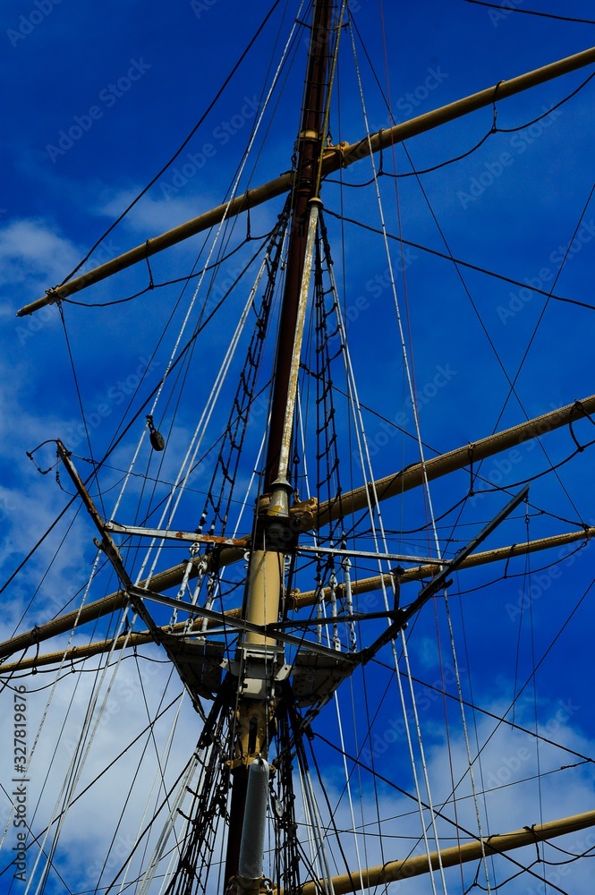 historic mast of the sailing ship ship with ropes against the blue sky historic mast of the sailing ship ship with ropes against the blue sky