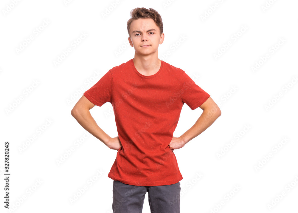 Fototapeta premium Upset handsome caucasian Teen Boy with hands on waist, isolated on white background. Angery teenager looking at camera. Unhappy child portrait.