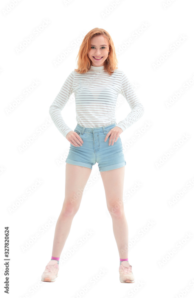 in full growth. confident model girl in jeans shorts in full growth. confident model girl in jeans shorts