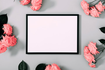 Beautiful flowers composition. Blank frame for text, pink rose flowers on gray background. Valentines Day, Birthday, Happy Women's Day, Mother's day. Flat lay, top view, copy space