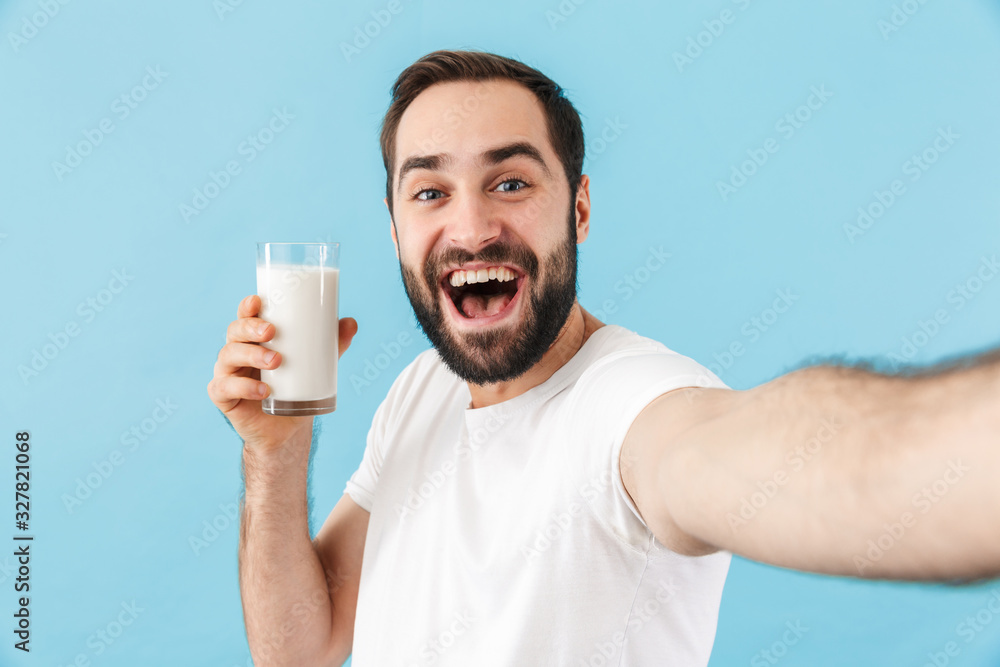 Portrait of a young cheerful bearded man wearing t-shirt Portrait of a young cheerful bearded man wearing t-shirt