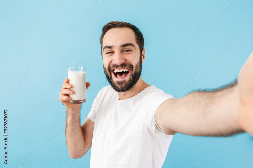 Portrait of a young cheerful bearded man wearing t-shirt Portrait of a young cheerful bearded man wearing t-shirt