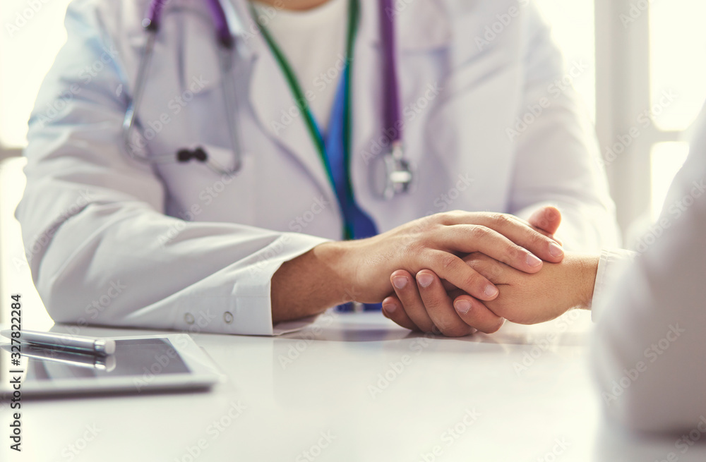 Close-up of stethoscope and paper on background of doctor and patient hands Close-up of stethoscope and paper on background of doctor and patient hands