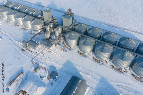 Fototapeta Naklejka Na Ścianę i Meble -  new built cereal elevator photographed from a drone at sunset in the winter