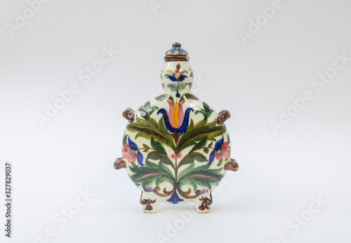 Old fayence flask with handpainted pattern - traditional antique ceramic drinking bottle