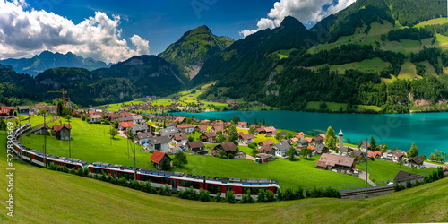 Famous electric red tourist panoramic train in swiss village Lungern, canton of Obwalden, Switzerland photo