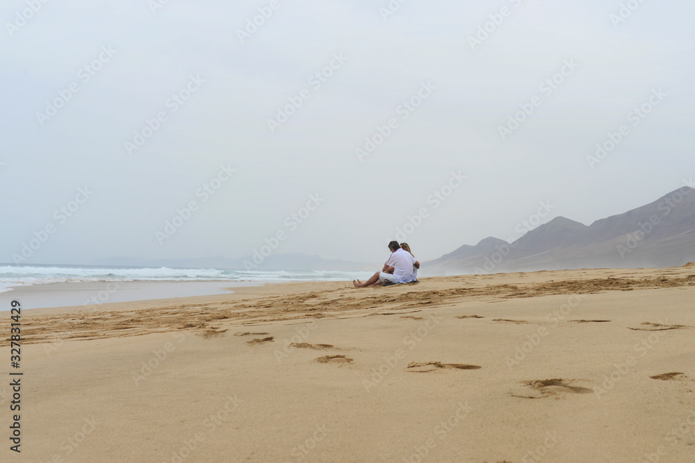 Lovers sitting on the shore of the Atlantic ocean