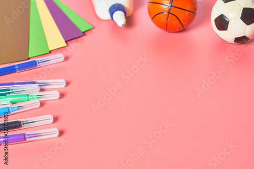 Stationery accessories and toys for child leisure and intellectual develop lies on pink desk. Copy space © OlekStock