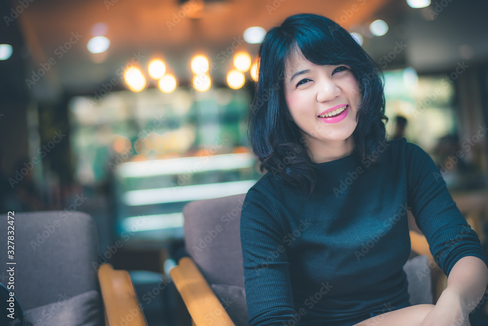 Beautiful attractive young Asian woman sitting at cafe or coffe shop in the morning Beautiful attractive young Asian woman sitting at cafe or coffe shop in the morning