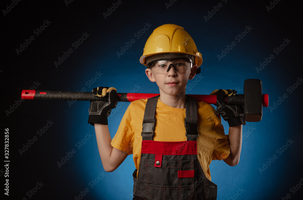 the child the Builder costume posing with a work tool