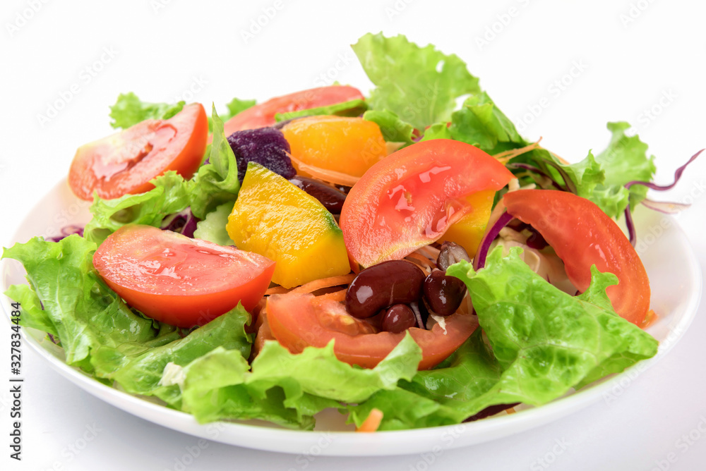 Fresh vegetable salad on plate over white background. Fresh vegetable salad on plate over white background.