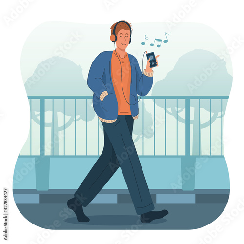 Young man listening to music while walking on the street. People wearing headphones