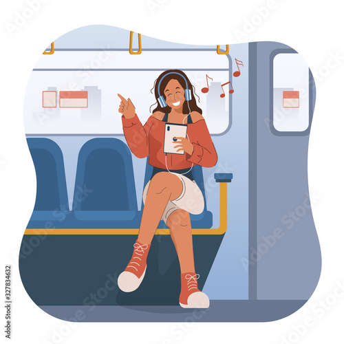 Happy young woman with headphones listening to music on subway train
