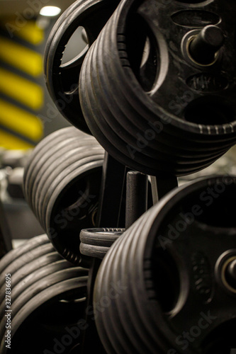 Weights in a workout gym. Gym interior close up, machinery and weightlifting equipment in modern urban style. © Inception