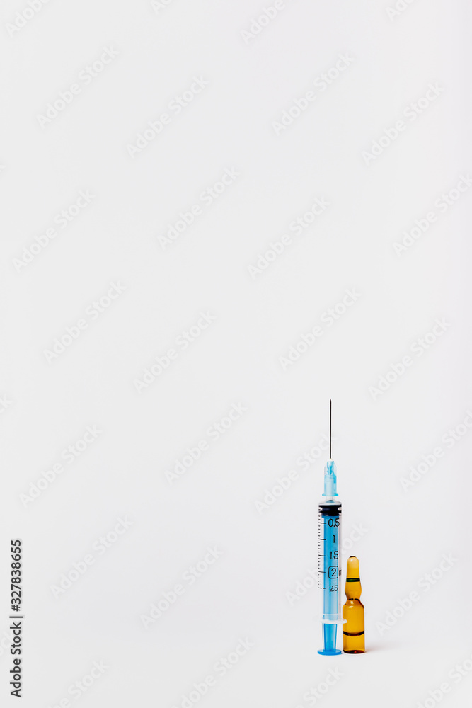 Syringe and vaccine on a white background. Injection on a white background Syringe and vaccine on a white background. Injection on a white background
