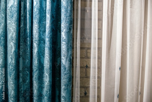 Blue and white curtains against the wall