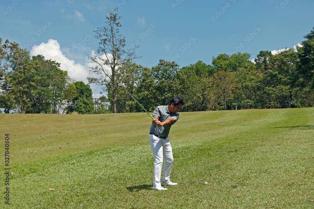 Golfer playing golf in beautiful golf course in the evening golf course Golfer playing golf in beautiful golf course in the evening golf course