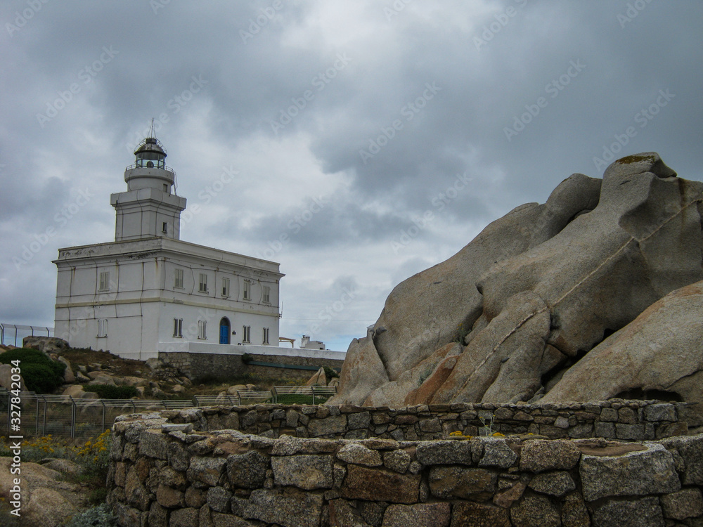 Capo Testa lighthouse in Sardinia on the rocks overlooking the blue sea Capo Testa lighthouse in Sardinia on the rocks overlooking the blue sea
