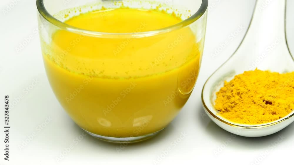 turmeric milk and powder on a turn table turmeric milk and powder on a turn table