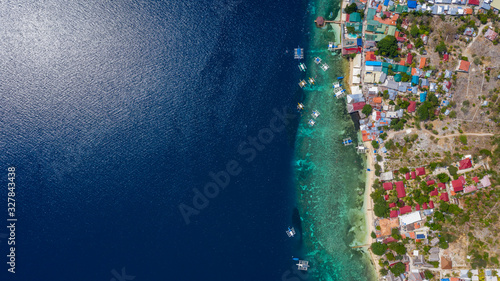 Aerial view local living of Philippines at Moalboal a small town on Cebu island, Moalboal is a deep clean blue ocean and has many local Filipino boats in the sea. Moalboal, Cebu, Philippines.