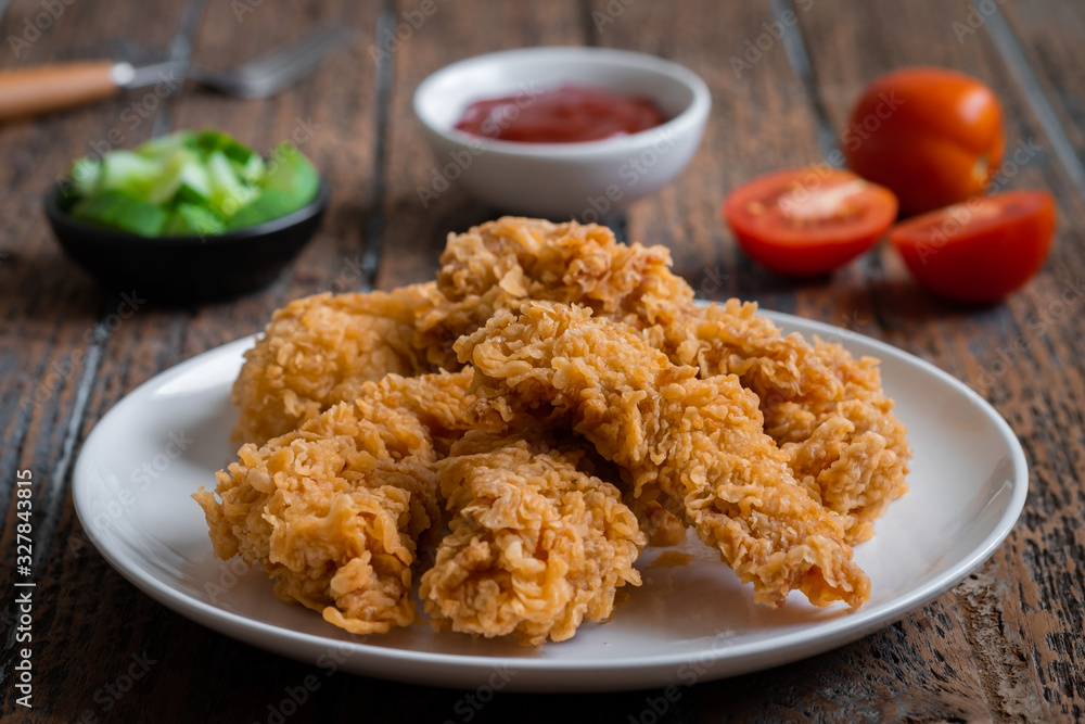 Crispy fried breaded chicken strips on plate and ketchup. Crispy fried breaded chicken strips on plate and ketchup.