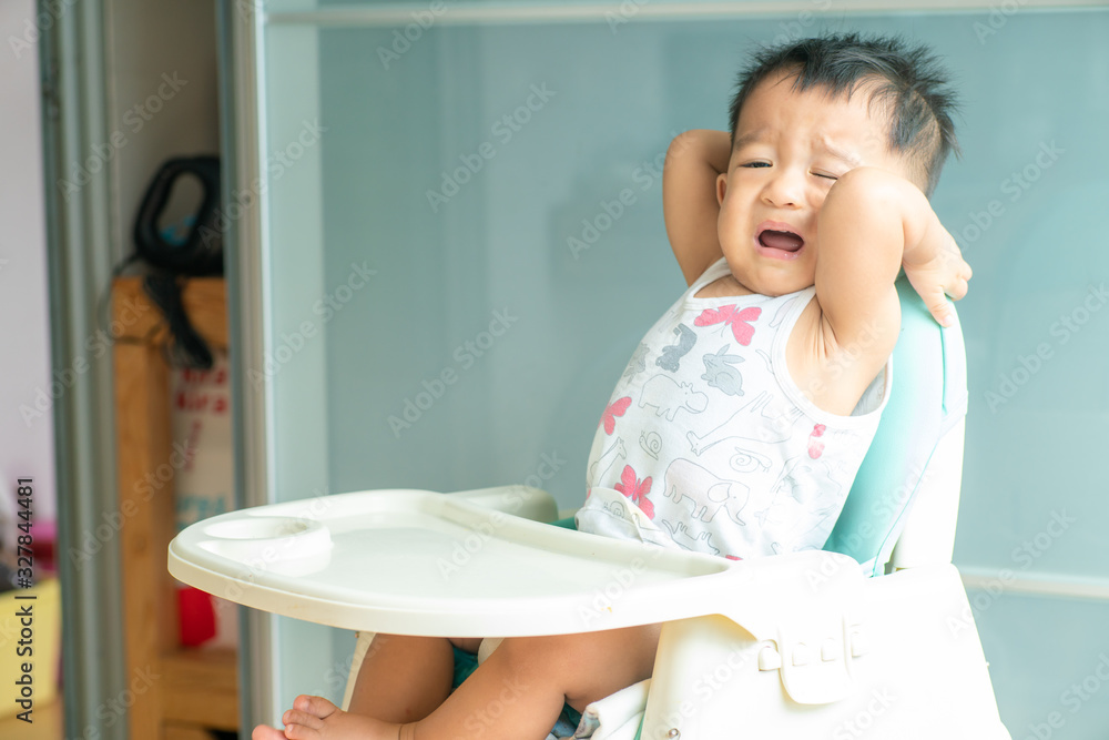 Portrait of happy young asian baby boy sitting in high food chair Portrait of happy young asian baby boy sitting in high food chair