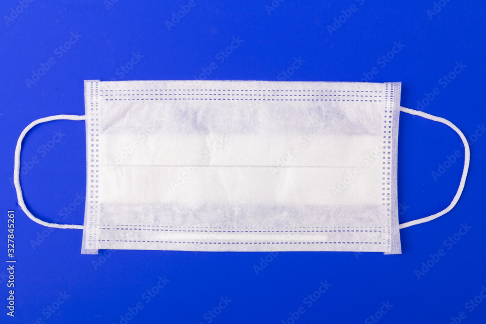 White medical mask isolated on red background. Face mask protection against pollution, virus, flu and coronavirus. White medical mask isolated on red background. Face mask protection against pollution, virus, flu and coronavirus.