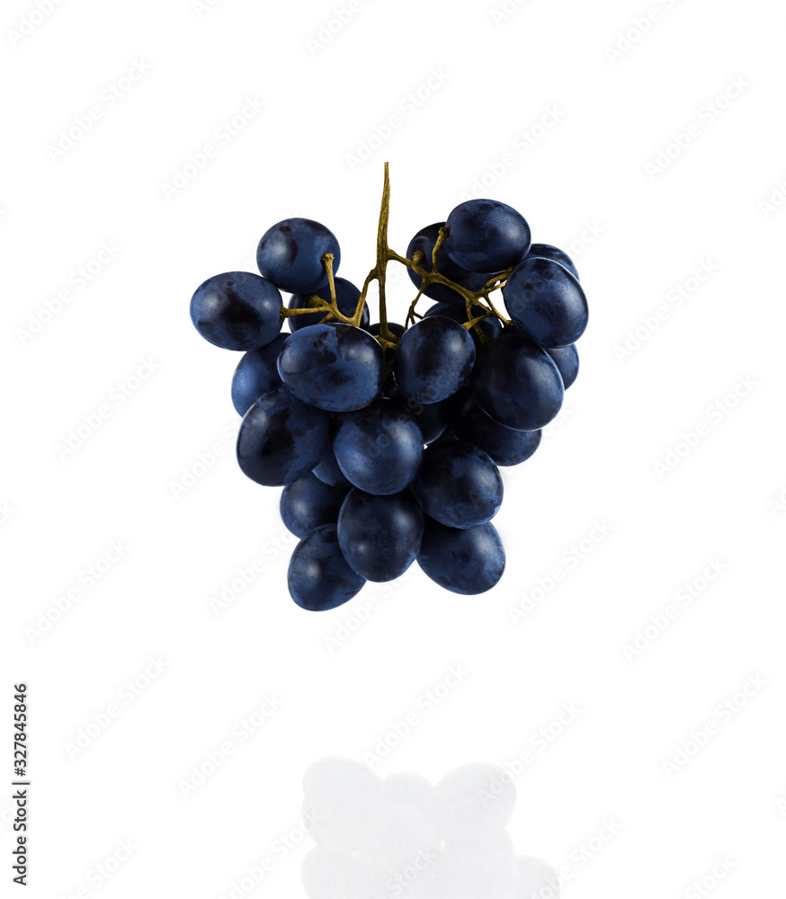 A bunch of grapes hanging in the air, isolated on a white background. Falling, flying food. Close up. A bunch of grapes hanging in the air, isolated on a white background. Falling, flying food. Close up.