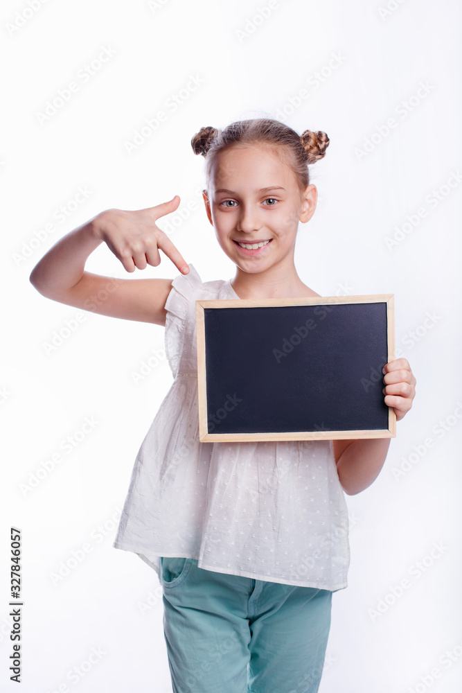 Little girl holding an empty Board on a white background. The child shows an empty Board. Concept of education. Little girl holding an empty Board on a white background. The child shows an empty Board. Concept of education.