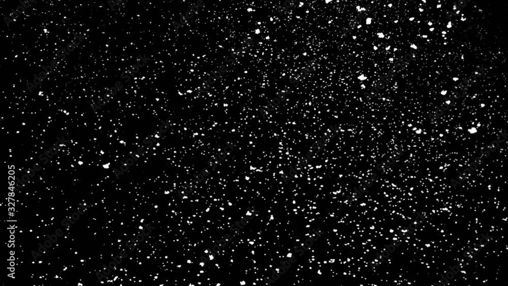 Falling snow particles isolated on black background with bokeh effect Falling snow particles isolated on black background with bokeh effect