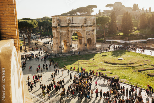 ROME, ITALY - MARCH 03, 2019: The Arch of Constantine during spring sunny day. A landscape view of the Arch of Constantine in sunny holidays, lots of tourists, spring vacation, Rome, Italy. photo