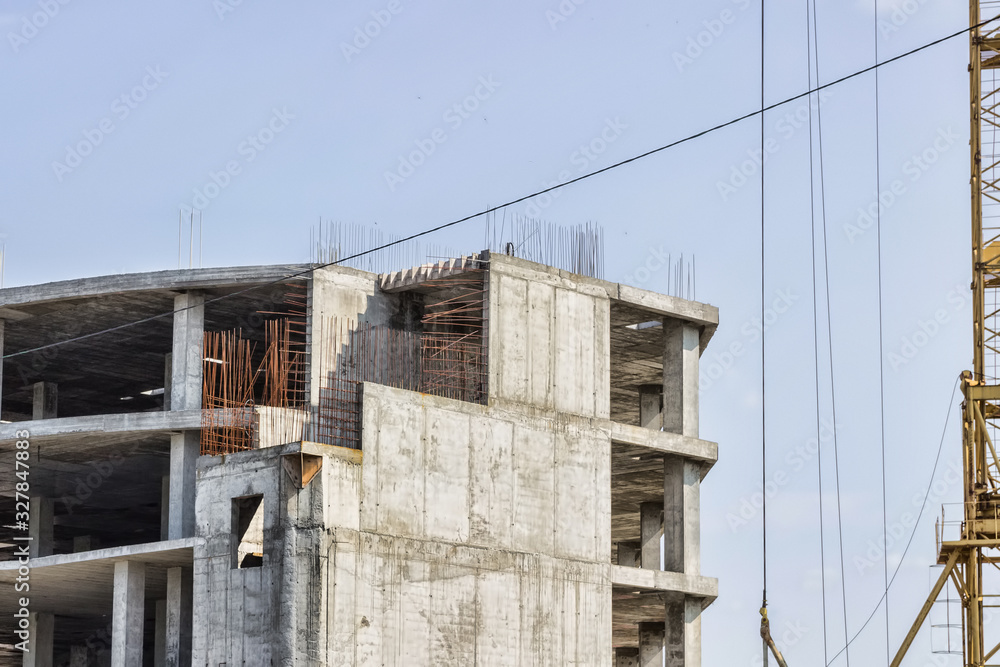 Construction of the building. Hoisting crane on blue sky background. Construction of the building. Hoisting crane on blue sky background.