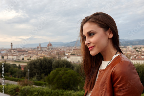 A young woman with a panorama of Florence behind her.