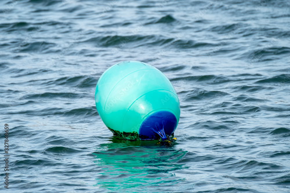 Green buoy swimming in the Atlantic Ocean Green buoy swimming in the Atlantic Ocean