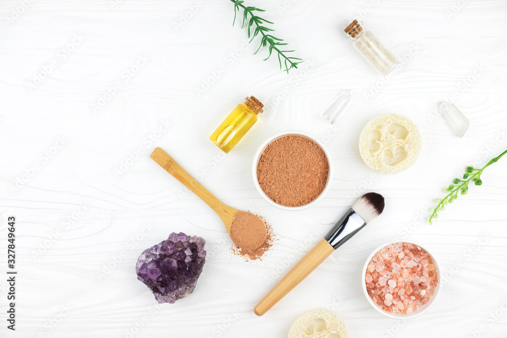 Homemade spa cosmetic set with salt, clay mask and oil on white wooden background. Copy space. Flat lay style. Homemade spa cosmetic set with salt, clay mask and oil on white wooden background. Copy space. Flat lay style.