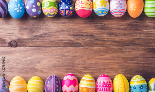 Painted colorful easter eggs on brown wood background