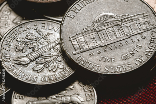 Money, Coin, Dollar, USD. Group of coin of US Dollar Coins on a table with red surface. Coins of Five Cents and One Dime.  photo