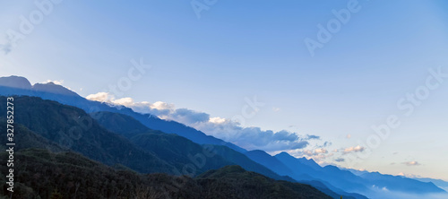 Mountain range silhouettes fog nature background © Emoji Smileys People
